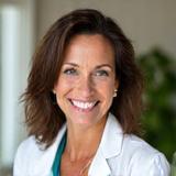 Portrait of Dr. Elara Reed, a warm and knowledgeable certified nutritionist with a kind smile.
